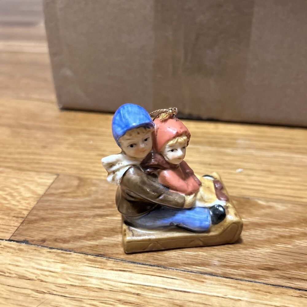 VINTAGE BRONSON ST NICK NACKS PORCELAIN CHILDREN SLEDDING ORNAMENT 2.5"X 2"
